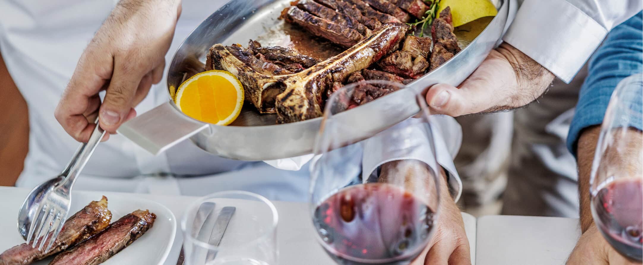 Steersons: Prime steak on plate with sides and wine